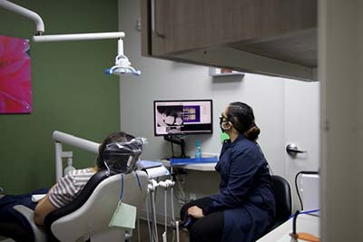 dentist reviewing an x-ray with patient while discussing restorative dental options